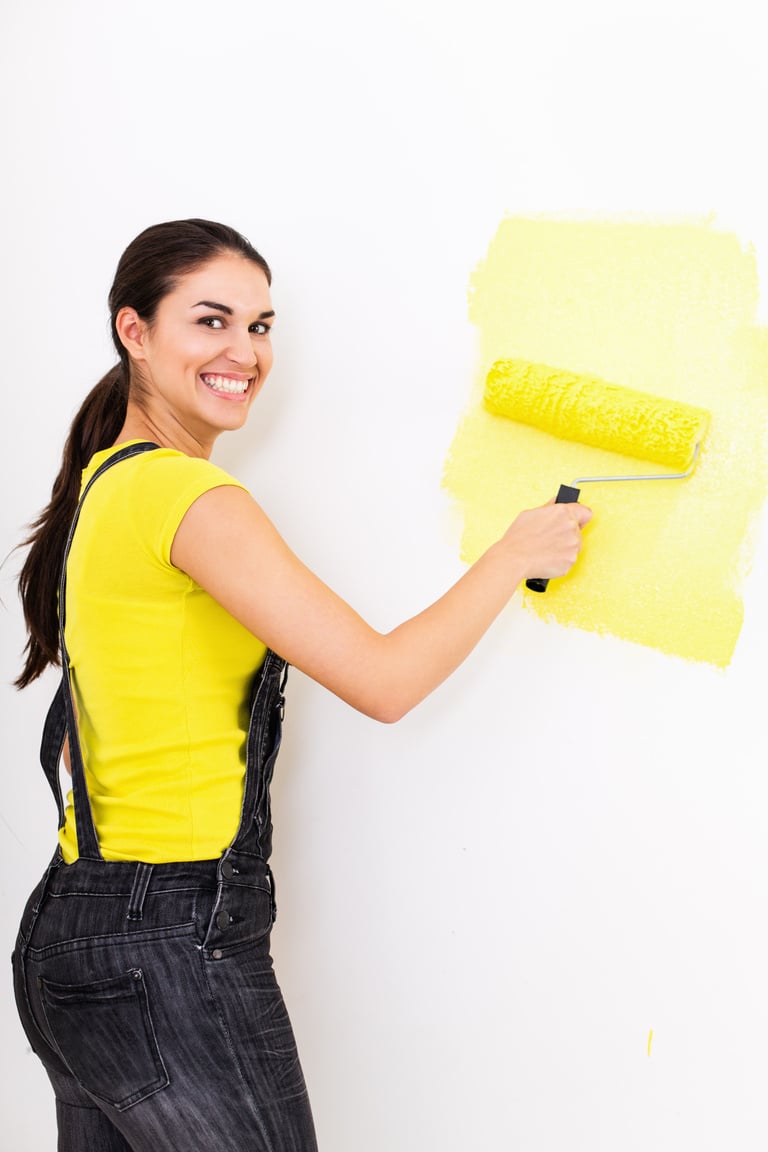 Woman painting wall